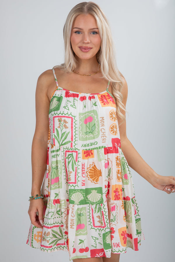 Woman wearing a colorful patterned dress on a plain background